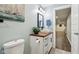 Bathroom with white vanity, modern vessel sink, wood countertop, and framed mirror at 18998 Beverly Shones Ln, Noblesville, IN 46062