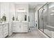 Modern bathroom with dual vanity, quartz countertop, and glass enclosed shower at 18998 Beverly Shones Ln, Noblesville, IN 46062