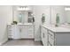 Bright bathroom featuring double sinks, white cabinets, quartz countertops, and tile flooring at 18998 Beverly Shones Ln, Noblesville, IN 46062