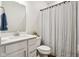 Bathroom features a modern white vanity with a countertop, a sink and a shower/tub with a patterned shower curtain at 18998 Beverly Shones Ln, Noblesville, IN 46062