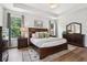 Spacious bedroom featuring tray ceiling, hardwood floors, and ample natural light at 18998 Beverly Shones Ln, Noblesville, IN 46062