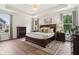Spacious bedroom with tray ceiling, hardwood floors, and large windows at 18998 Beverly Shones Ln, Noblesville, IN 46062