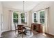 Cozy dining room with natural light, chandelier, and wood furnishings at 18998 Beverly Shones Ln, Noblesville, IN 46062