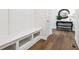 Hallway features storage bench, hardwood floors and a decorative mirror at 18998 Beverly Shones Ln, Noblesville, IN 46062