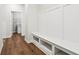 Hallway features storage bench and access to the laundry room with washer and dryer at 18998 Beverly Shones Ln, Noblesville, IN 46062