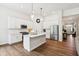 Bright kitchen features white cabinets, stainless steel appliances, and a kitchen island at 18998 Beverly Shones Ln, Noblesville, IN 46062