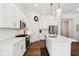 Well-lit kitchen with stainless steel appliances, white cabinets and a view to the living area at 18998 Beverly Shones Ln, Noblesville, IN 46062