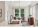 Kitchen with an eat-in dining area features a chandelier and a large window showcasing the lush greenery of the outdoors at 18998 Beverly Shones Ln, Noblesville, IN 46062