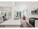 Bright kitchen boasts stainless steel appliances, white cabinetry, and a center island with modern countertops and a sink at 18998 Beverly Shones Ln, Noblesville, IN 46062