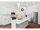 Modern kitchen boasts white cabinetry, a center island, and stainless steel appliances at 18998 Beverly Shones Ln, Noblesville, IN 46062