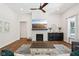 Bright living room with a modern fireplace, a wooden mantel, and an open floor plan at 18998 Beverly Shones Ln, Noblesville, IN 46062