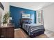 Blue main bedroom boasts a decorative wall, comfy bed, stylish furnishings, and natural light from the window at 18998 Beverly Shones Ln, Noblesville, IN 46062