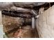 Unfinished basement with exposed pipes, concrete walls, and visible water heater at 1938 N Dearborn St, Indianapolis, IN 46218