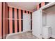 Bedroom with black and pink striped walls and door leading to an ensuite bath at 1938 N Dearborn St, Indianapolis, IN 46218