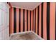 Bedroom with black and pink striped walls and door leading to another room at 1938 N Dearborn St, Indianapolis, IN 46218