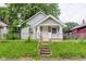 Charming home featuring a covered front porch and a well-manicured front yard at 1938 N Dearborn St, Indianapolis, IN 46218