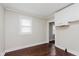 Bright kitchen with white cabinets, hardwood floors, and natural light from the window at 1938 N Dearborn St, Indianapolis, IN 46218