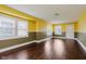 Large, light-filled living room featuring hardwood flooring and large windows for ample light at 1938 N Dearborn St, Indianapolis, IN 46218