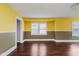 Bright living room featuring hardwood flooring and a large window for ample natural light at 1938 N Dearborn St, Indianapolis, IN 46218