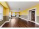 Open living room with hardwood flooring, neutral paint, and a glimpse into an adjoining room at 1938 N Dearborn St, Indianapolis, IN 46218