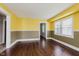 Living room featuring hardwood flooring and large windows providing ample natural light at 1938 N Dearborn St, Indianapolis, IN 46218