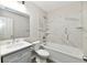 Modern bathroom with marble tile surround, vanity, and sleek fixtures at 2026 Spruce St, Indianapolis, IN 46203