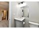 Well-lit bathroom featuring a gray vanity with marble countertop, a mirror, and a toilet at 2026 Spruce St, Indianapolis, IN 46203