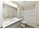 Bright bathroom featuring a white vanity, well-lit mirror, and tub with shower at 2026 Spruce St, Indianapolis, IN 46203