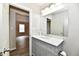 Bathroom vanity with white marble countertop, large mirror, and doorway view at 2026 Spruce St, Indianapolis, IN 46203