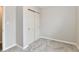 Carpeted bedroom with closet featuring bi-fold doors and neutral decor at 2026 Spruce St, Indianapolis, IN 46203