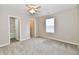 Bedroom with a ceiling fan and a window, with an ensuite bathroom and walk in closet at 2026 Spruce St, Indianapolis, IN 46203