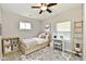 Neutral bedroom with a single bed, desk, and a window allowing natural light at 2026 Spruce St, Indianapolis, IN 46203