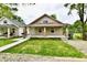 Charming one-story home featuring a welcoming porch, neat landscaping and a well-maintained lawn, enhancing curb appeal at 2026 Spruce St, Indianapolis, IN 46203