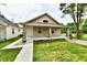 Charming single-story home featuring a welcoming front porch and well-maintained lawn, creating a cozy curb appeal at 2026 Spruce St, Indianapolis, IN 46203