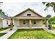 Charming single-story home with a covered front porch, well-maintained lawn, and inviting curb appeal at 2026 Spruce St, Indianapolis, IN 46203