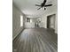 Open-concept living room featuring hardwood floors and a ceiling fan, connecting to a modern kitchen at 2026 Spruce St, Indianapolis, IN 46203