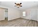 Bright living room with hardwood floors and a ceiling fan, complemented by abundant natural light from the windows at 2026 Spruce St, Indianapolis, IN 46203