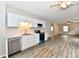 Open-concept living space with wood-look floors and stainless steel appliances at 2026 Spruce St, Indianapolis, IN 46203