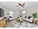 Comfortable living room featuring a neutral sofa, modern rug, and a ceiling fan with lights at 2026 Spruce St, Indianapolis, IN 46203