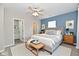 Bright bedroom with a large bed, a cozy bench, and an attached bathroom for convenience at 2026 Spruce St, Indianapolis, IN 46203