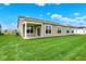 A view of the home's backyard features a well-manicured lawn, neutral siding, and an inviting covered patio at 2035 Frost Line Ln, Greenfield, IN 46140