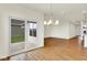 Open dining area with sliding glass doors to the patio, hardwood floors, and modern light fixture at 2035 Frost Line Ln, Greenfield, IN 46140