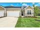 Charming single-Gathering home featuring a well-manicured lawn, stone accents, and an attached two-car garage at 2035 Frost Line Ln, Greenfield, IN 46140