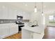 Contemporary kitchen showcases white cabinets, stainless steel appliances, and a stylish gray backsplash at 2035 Frost Line Ln, Greenfield, IN 46140