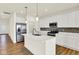 Modern kitchen with white cabinets, stainless steel appliances, and a large island with sink at 2035 Frost Line Ln, Greenfield, IN 46140