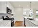 Modern kitchen with stainless steel appliances, quartz countertops, and a stylish sink and gas range at 2035 Frost Line Ln, Greenfield, IN 46140