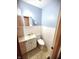 Bright half-bath features a toilet, sink, mirror, and tiled flooring, offering convenience and style at 22 Brooklyn Ct, Mooresville, IN 46158