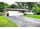 Home with a large driveway, attached garage, and well-kept lawn showcasing the exterior at 22 Brooklyn Ct, Mooresville, IN 46158