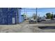 A long alleyway view, flanked by a blue brick building and various parked trucks and vans at 22 W 8Th St, Anderson, IN 46016