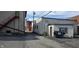 A back alley between commercial buildings with a dumpster and an emergency exit at 22 W 8Th St, Anderson, IN 46016